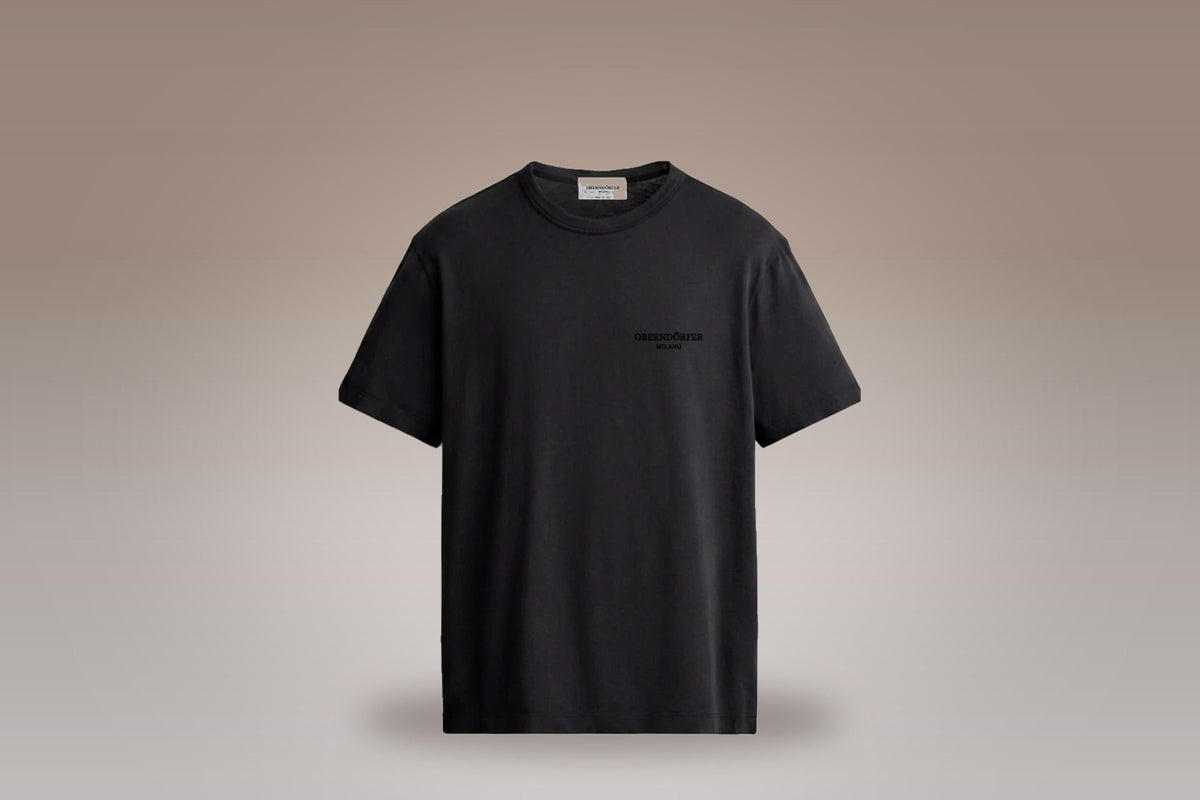 Embroidered T-Shirt in black on a taupe studio ground - Oberndörfer Milano Ready to Wear