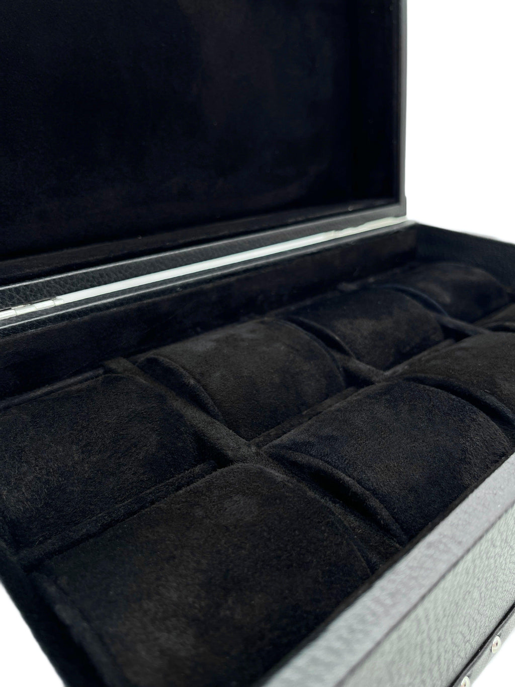 Open black leather watch box with soft velvet compartments for storage