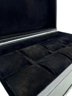 Open black leather watch box with soft velvet compartments for storage