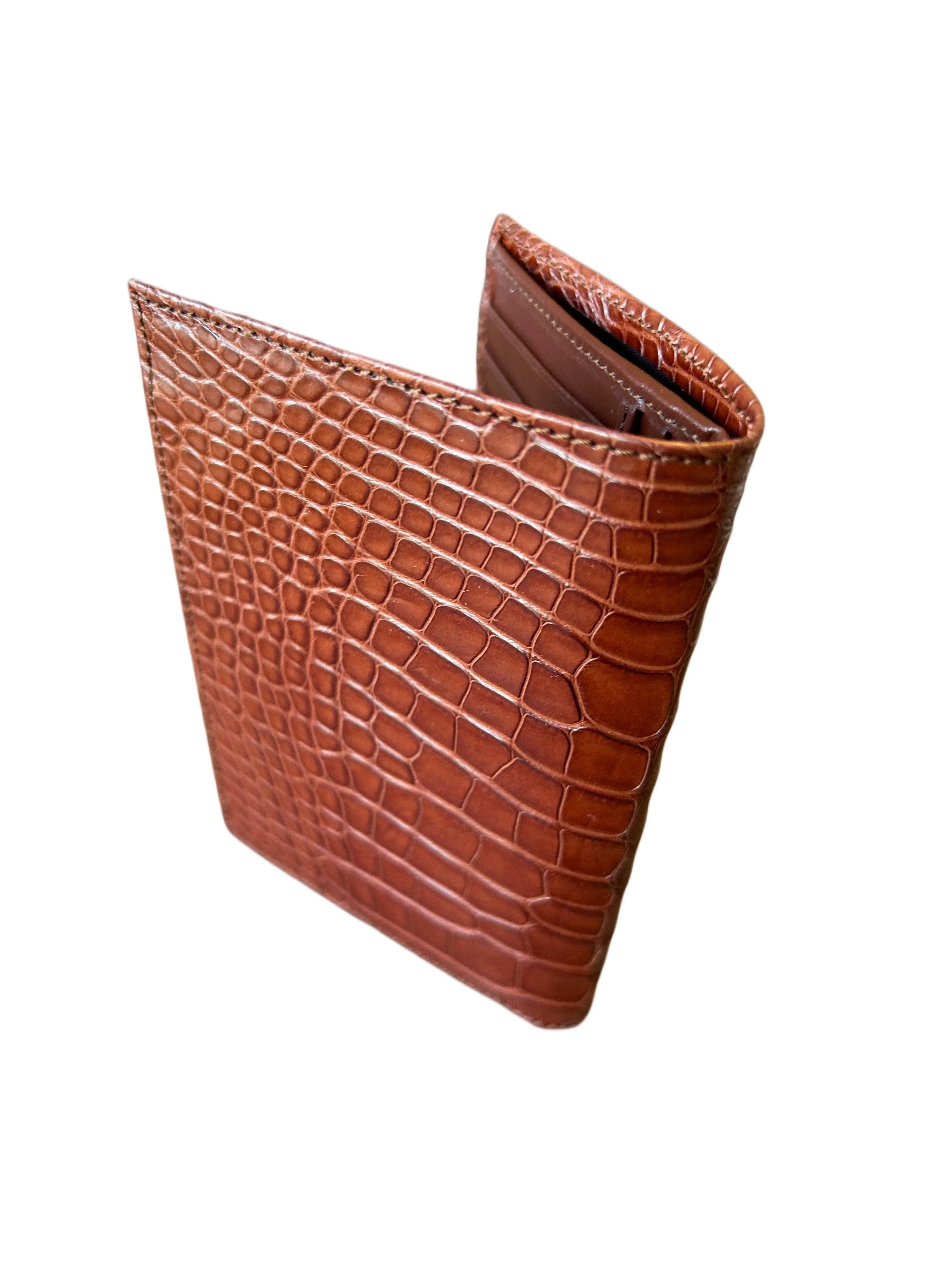 Brown crocodile-embossed bifold leather wallet with card slots, isolated on white background