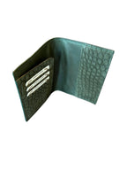 Open green textured leather wallet with card slots, handcrafted luxury accessory