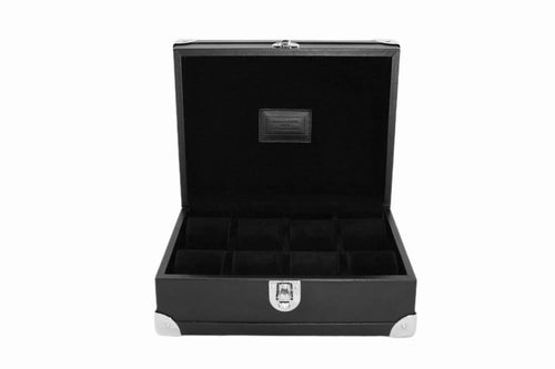 Black leather watch box with open lid, velvet interior, and metal corner accents