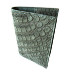 Handcrafted Italian wallet with textured crocodile-embossed green leather, angled view