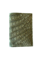 Green crocodile-embossed leather wallet, handcrafted, luxury Italian accessory on white background