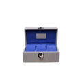 Handcrafted grey leather watch box with blue velvet interior and metal clasp, open and empty.