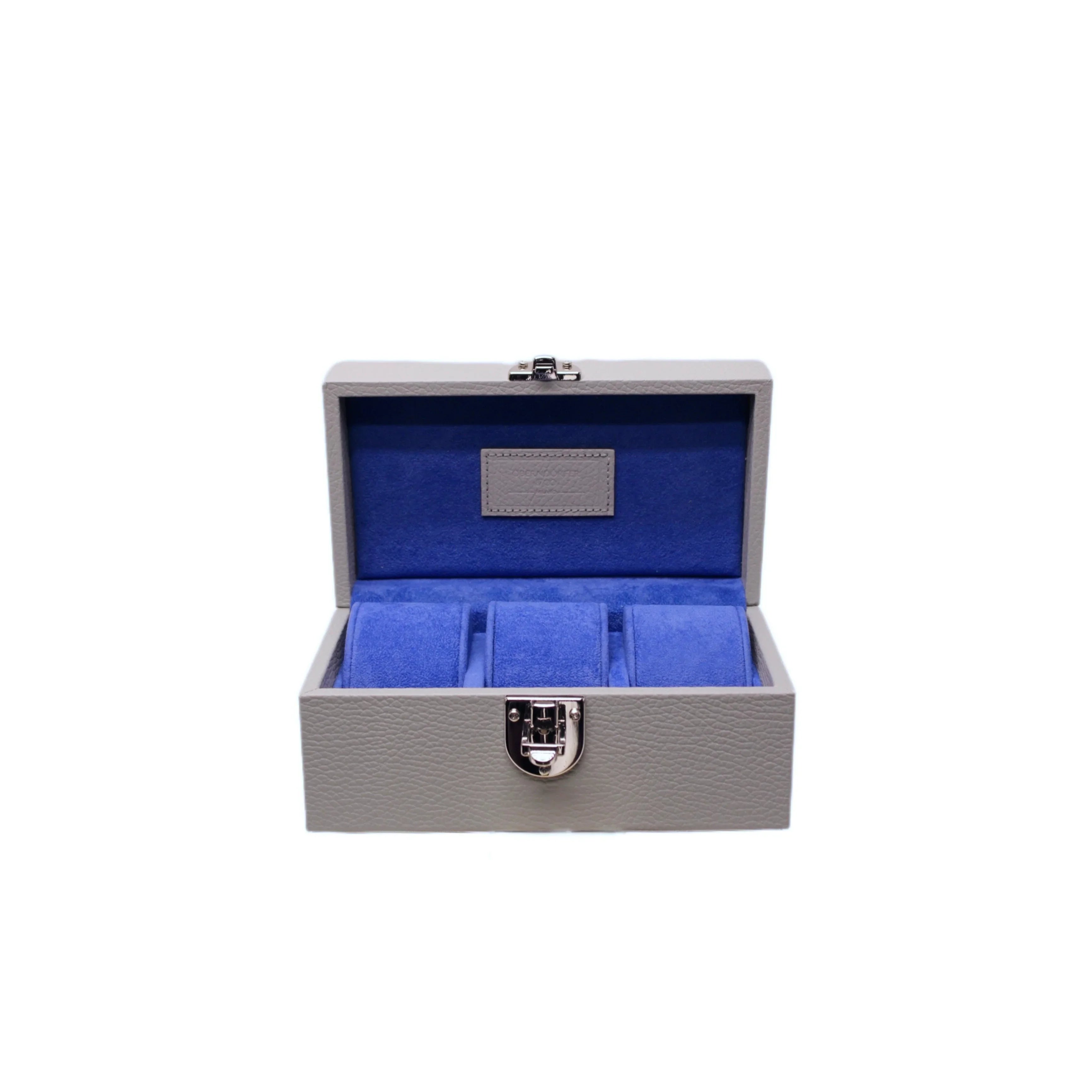 Handcrafted grey leather watch box with blue velvet interior and metal clasp, open and empty.