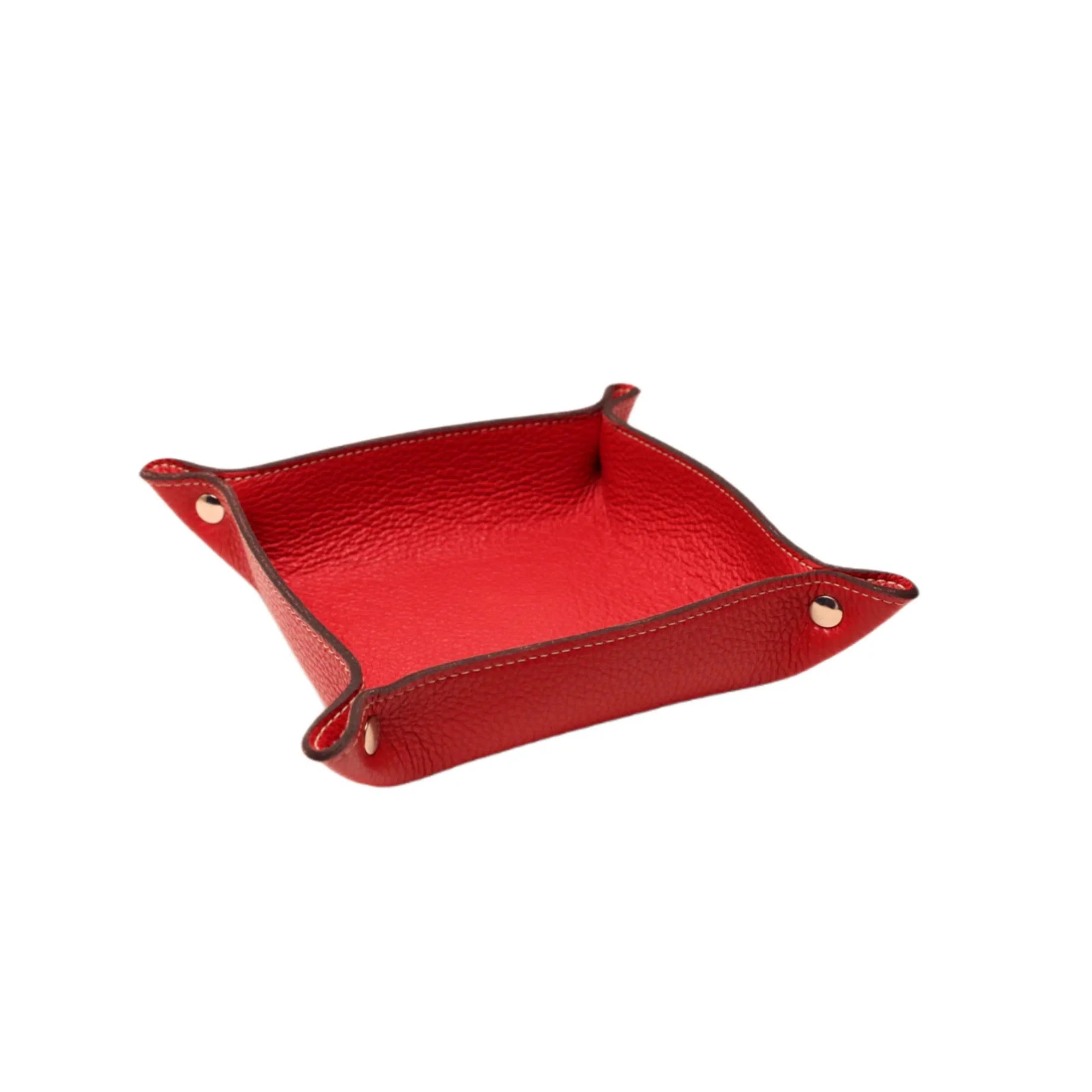 Red pebbled leather valet tray with gold snap buttons on a white background.