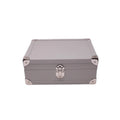 Taupe leather jewelry box with metal corners and silver clasp, luxury storage case