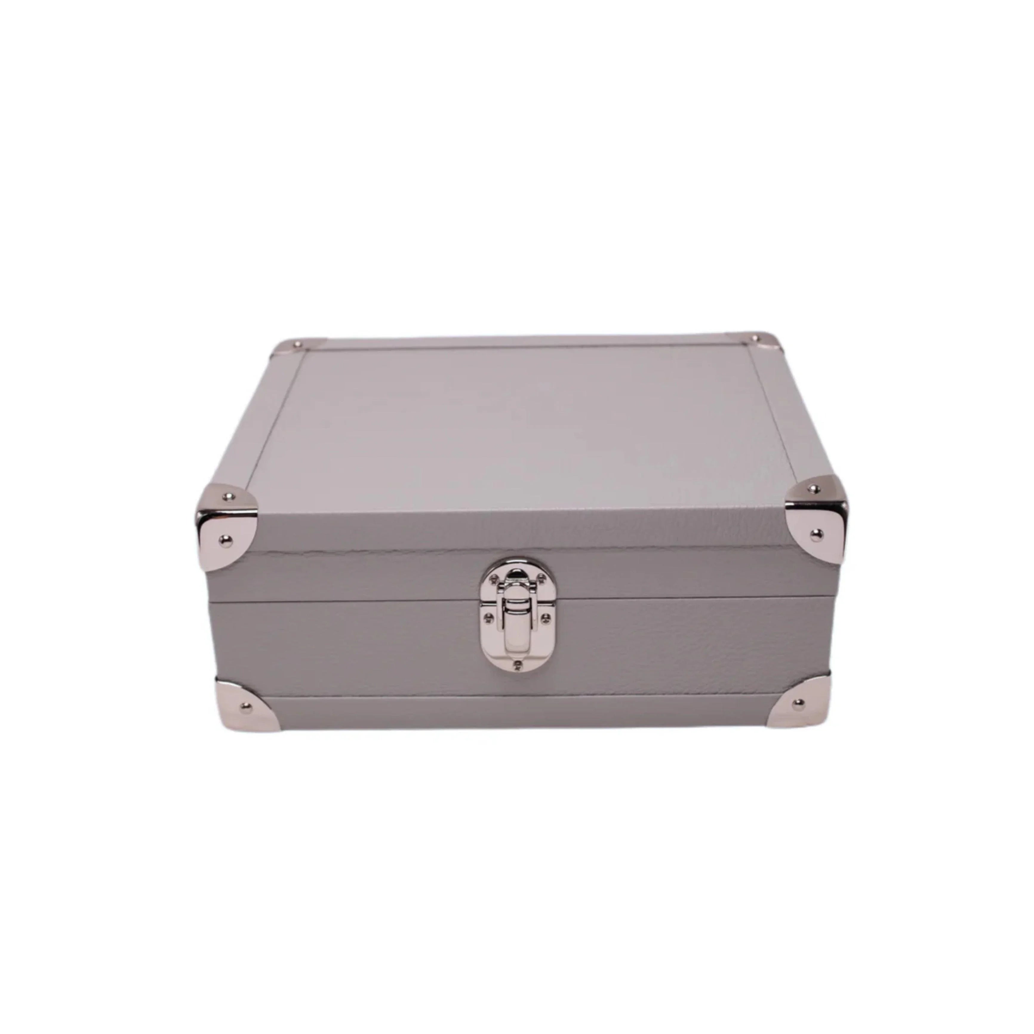 Taupe leather jewelry box with metal corners and silver clasp, luxury storage case