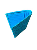 Turquoise crocodile leather wallet, standing upright on white background