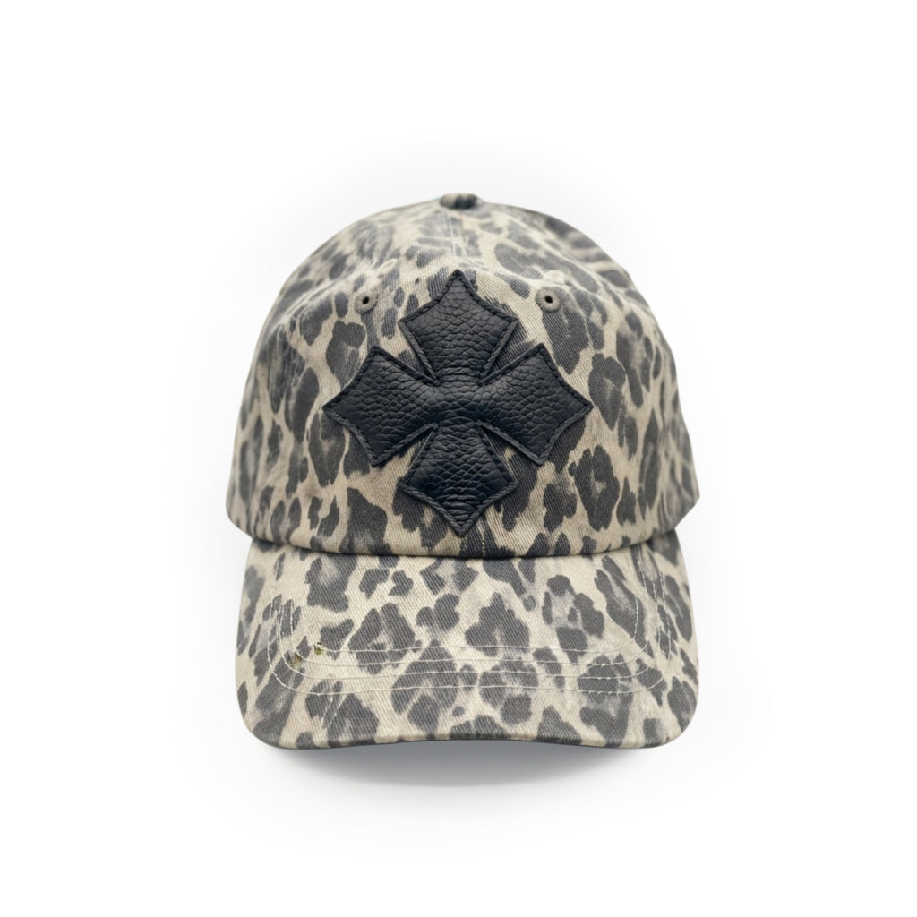 Front view of a stone and charcoal leopard print washed cotton baseball cap with a black calf leather logo patch