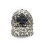 Front view of a stone and charcoal leopard print washed cotton baseball cap with a black calf leather logo patch