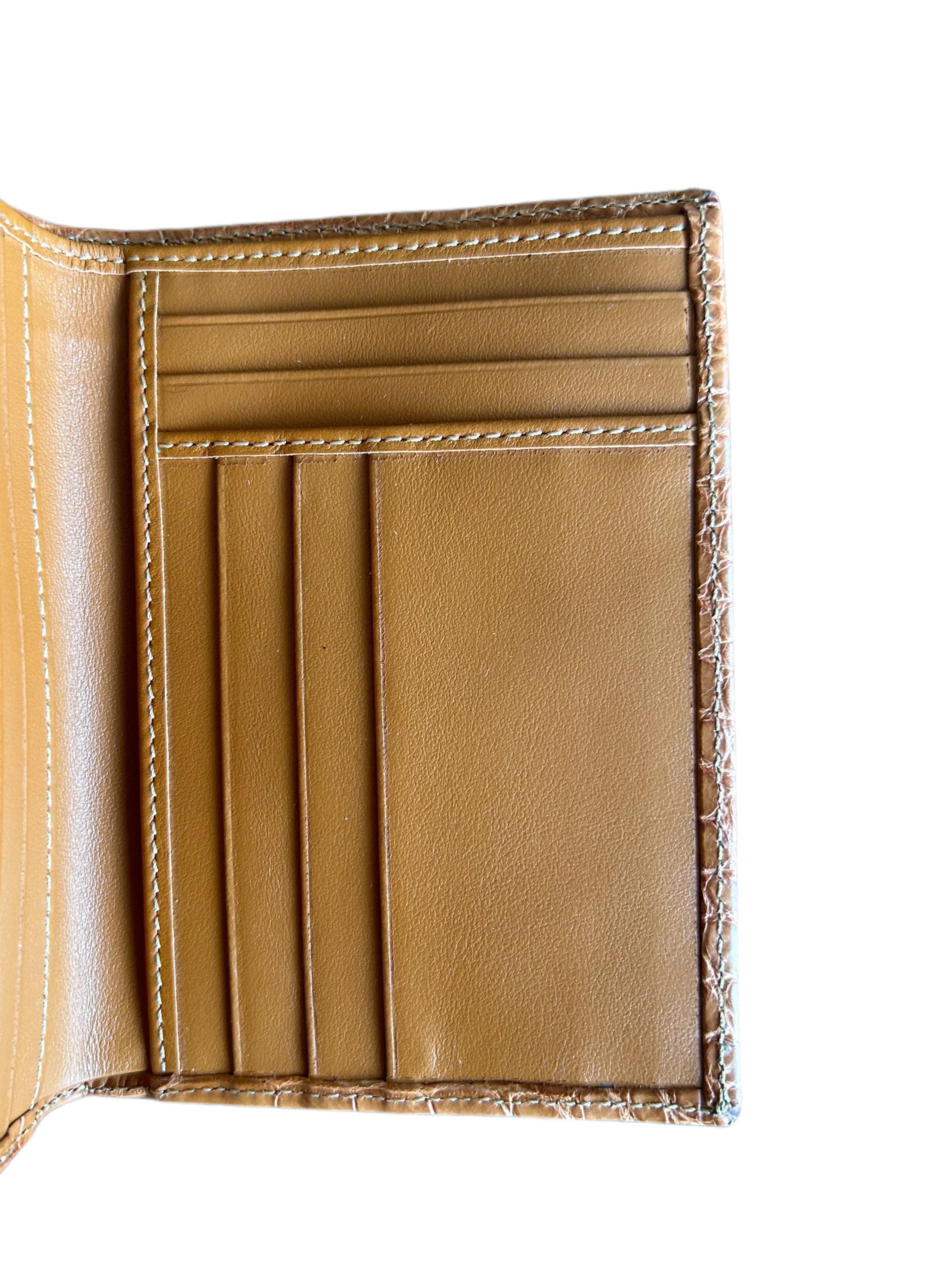Interior of tan leather wallet with multiple card slots and detailed stitching