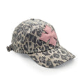 Three-quarter view of the leopard print washed cotton cap showing the pink calf leather logo patch