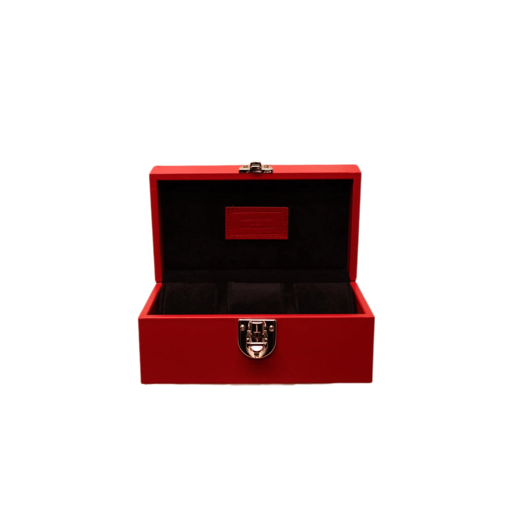 Red Italian leather watch box with black velvet interior and silver clasp, open lid