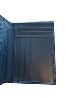 Open blue leather wallet with card slots and textured edges on white background