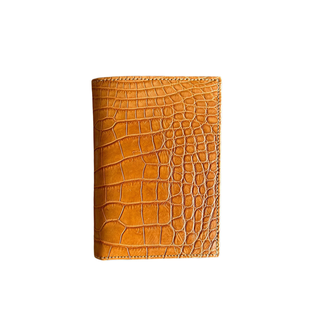 Tan crocodile embossed leather wallet, handcrafted luxury accessory on white background