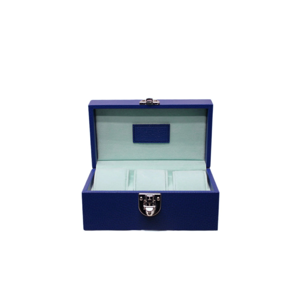 Open blue leather jewelry box with soft light interior and silver clasp