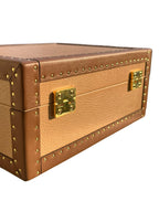 Brown leather jewelry box with gold hardware on a white background