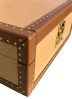 Close-up of a brown leather box with gold hardware