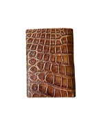 Chocolate brown crocodile leather wallet close-up of exotic leather texture