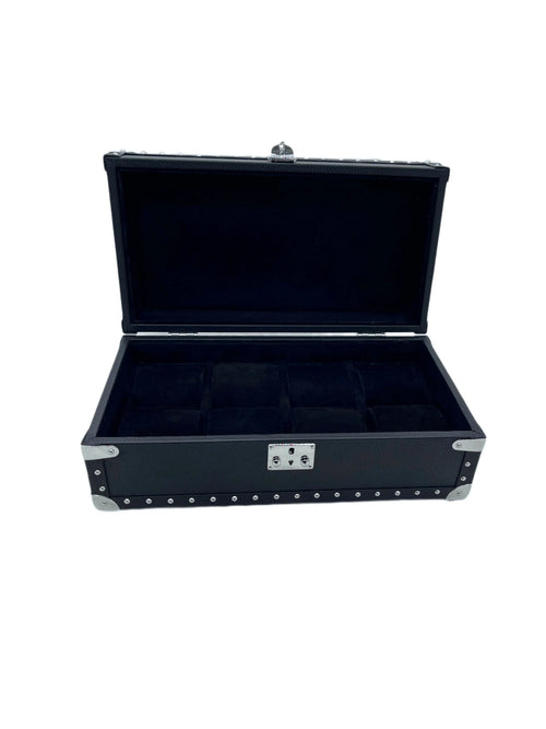 Open black leather watch box with metal accents and multiple compartments on white background