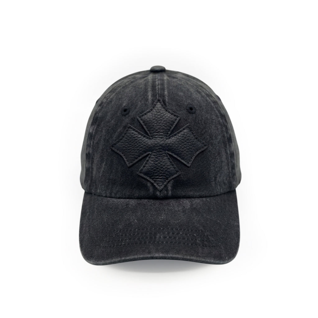Front view of a black washed cotton six-panel baseball cap with a tonal black calf leather logo patch