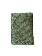 Handcrafted green textured leather wallet with reptile pattern on a white background
