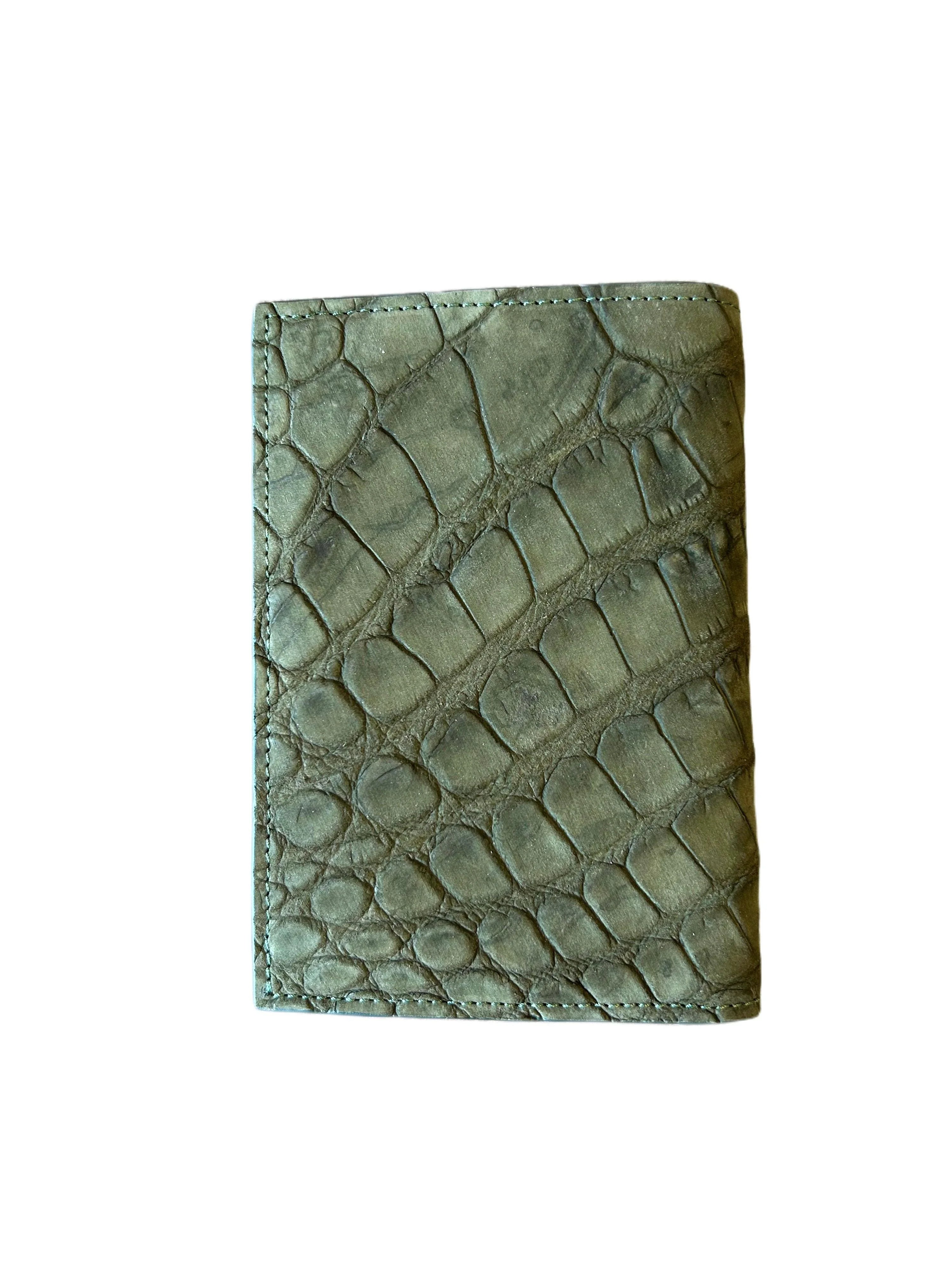 Handcrafted green textured leather wallet with reptile pattern on a white background