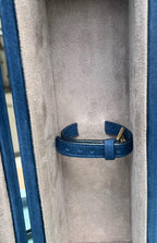 Wine Holder Leather Box close-up of blue leather retaining strap against grey suede lining