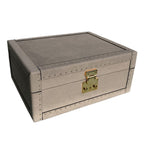Gray leather storage box with gold latch on a white background