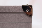 Close-up of gray textured leather box corner with silver metal edge detail