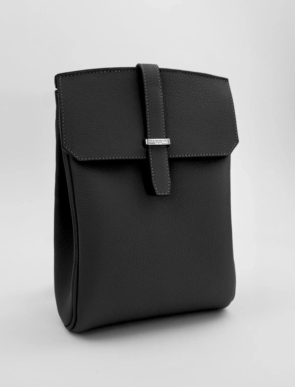 Black leather handbag on a light gray background