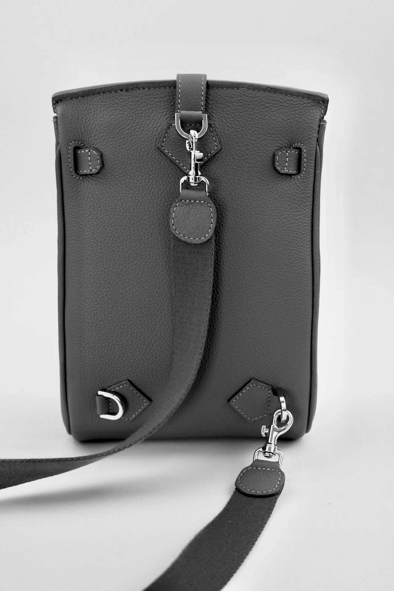 Grey belt bag with a strap on a white background