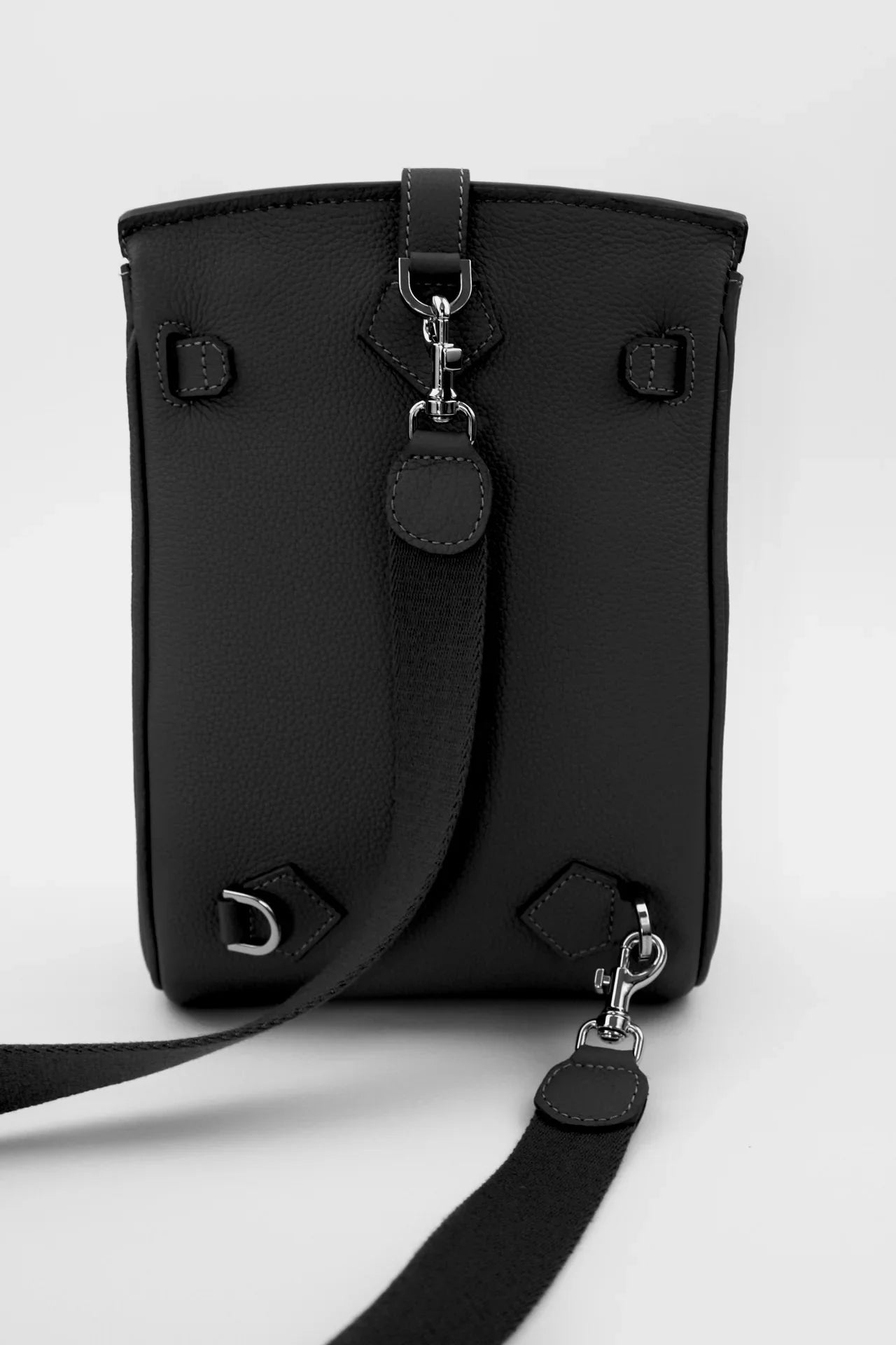 Black belt bag with a strap on a white background