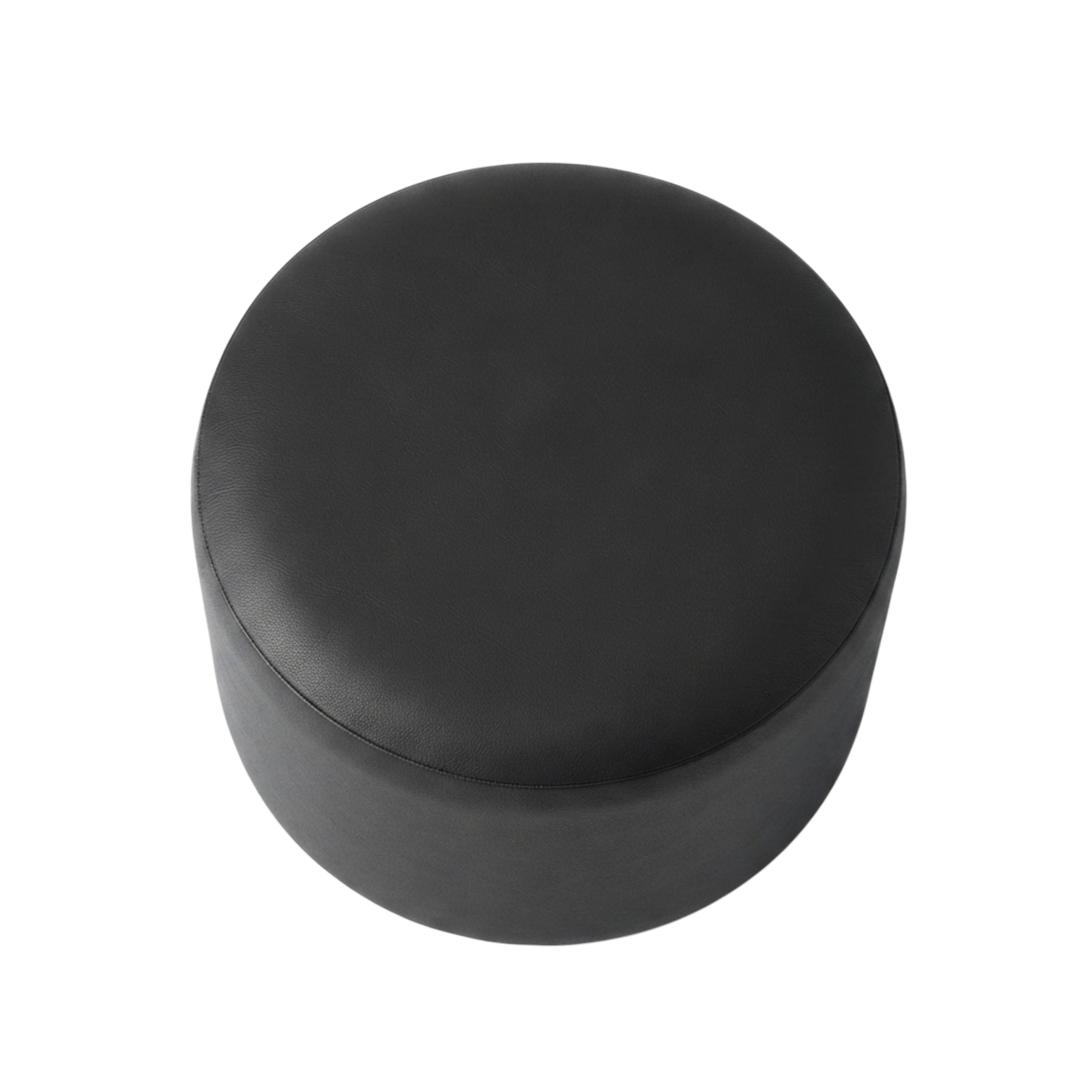 A round black upholstered ottoman or stool with a smooth matte finish, shown from a top-down perspective on a plain white background.