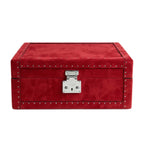 Red leather trunk with silver studs and lock on a white background