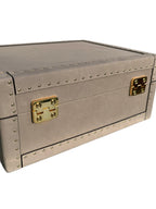 back of grey storage trunk with gold hardware