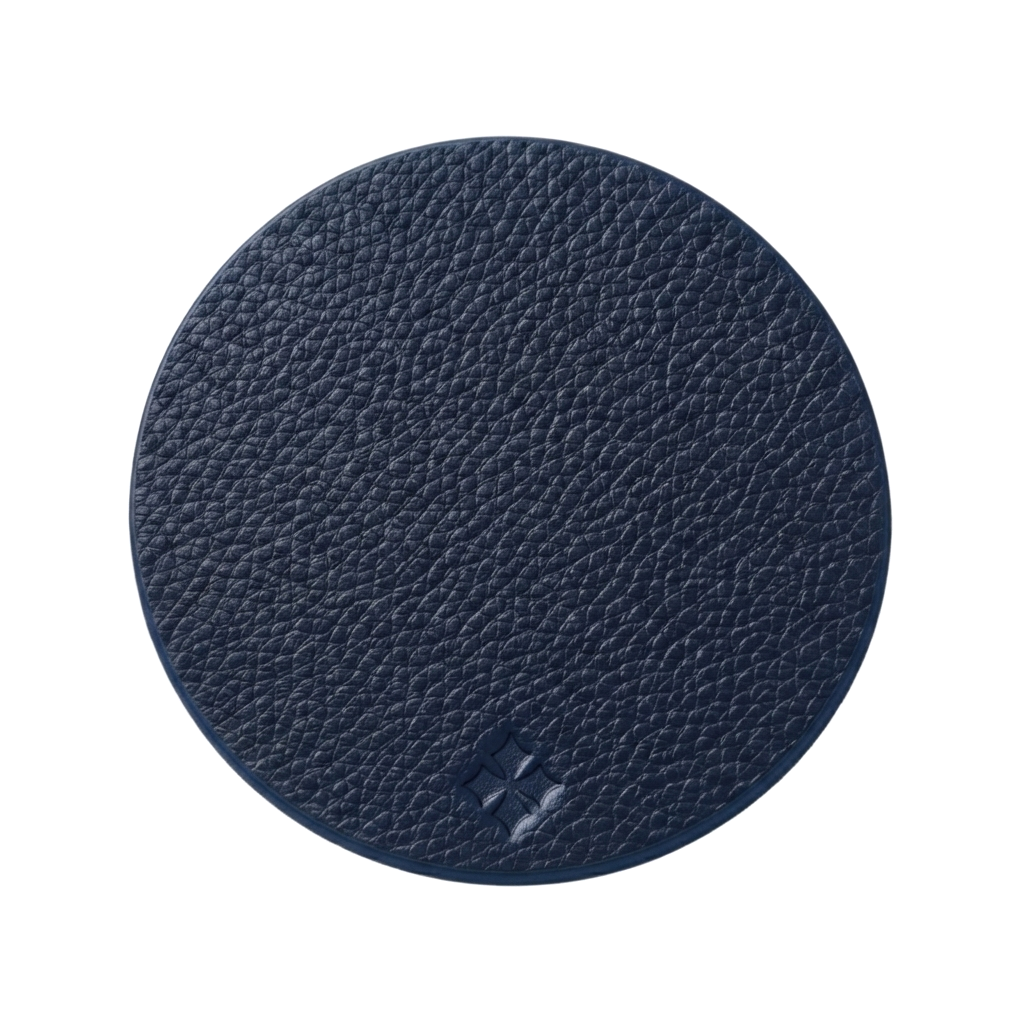 A round navy blue textured leather coaster on a solid white background.