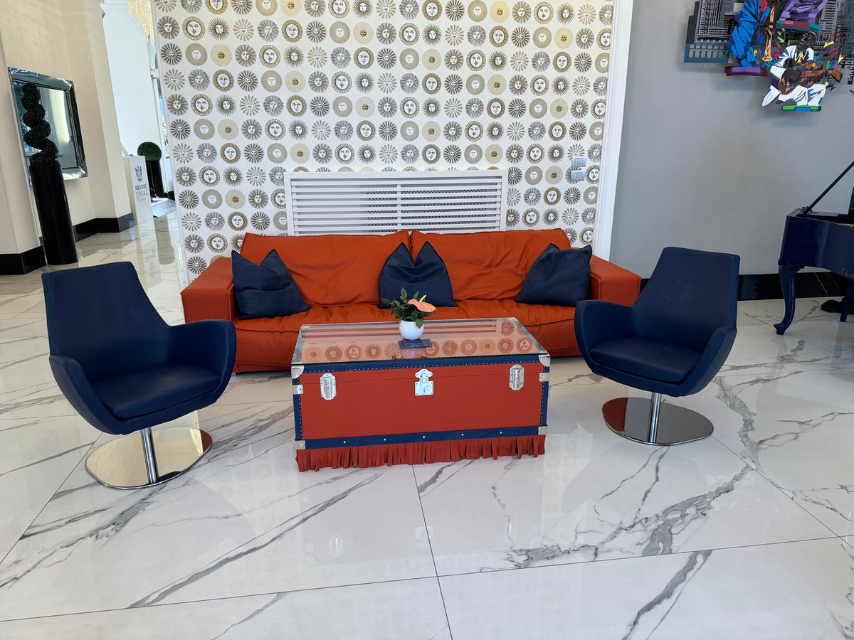 Oberndörfer Milano furniture at the Miramare Palace Sanremo: orange leather sofa, navy armchairs and a leather trunk table