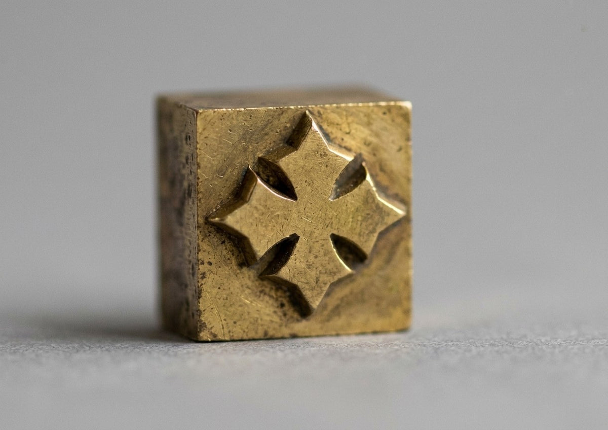 A brass stamp engraved with the Oberndörfer cross