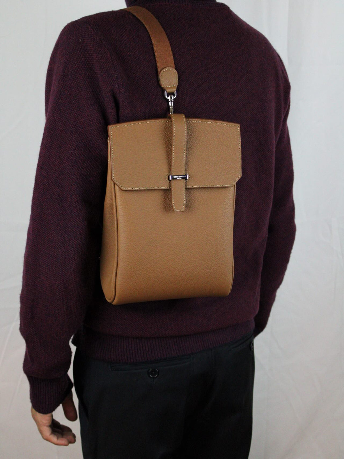 The Sac in tan leather, worn across the body