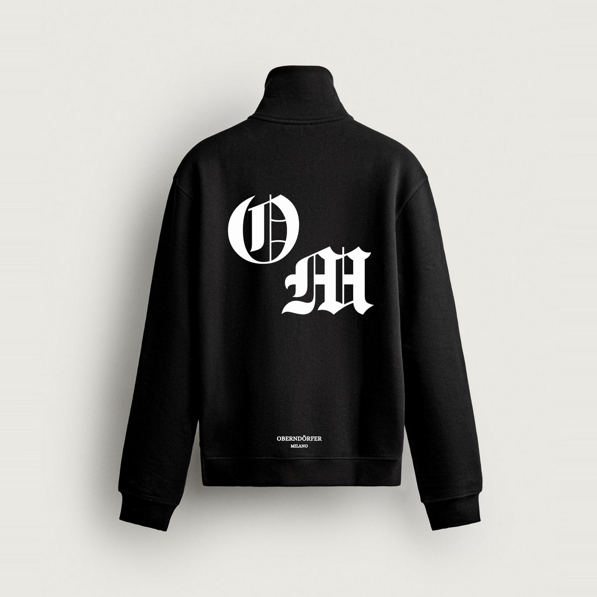 Half-Zip OM in black, back, O and M in white blackletter