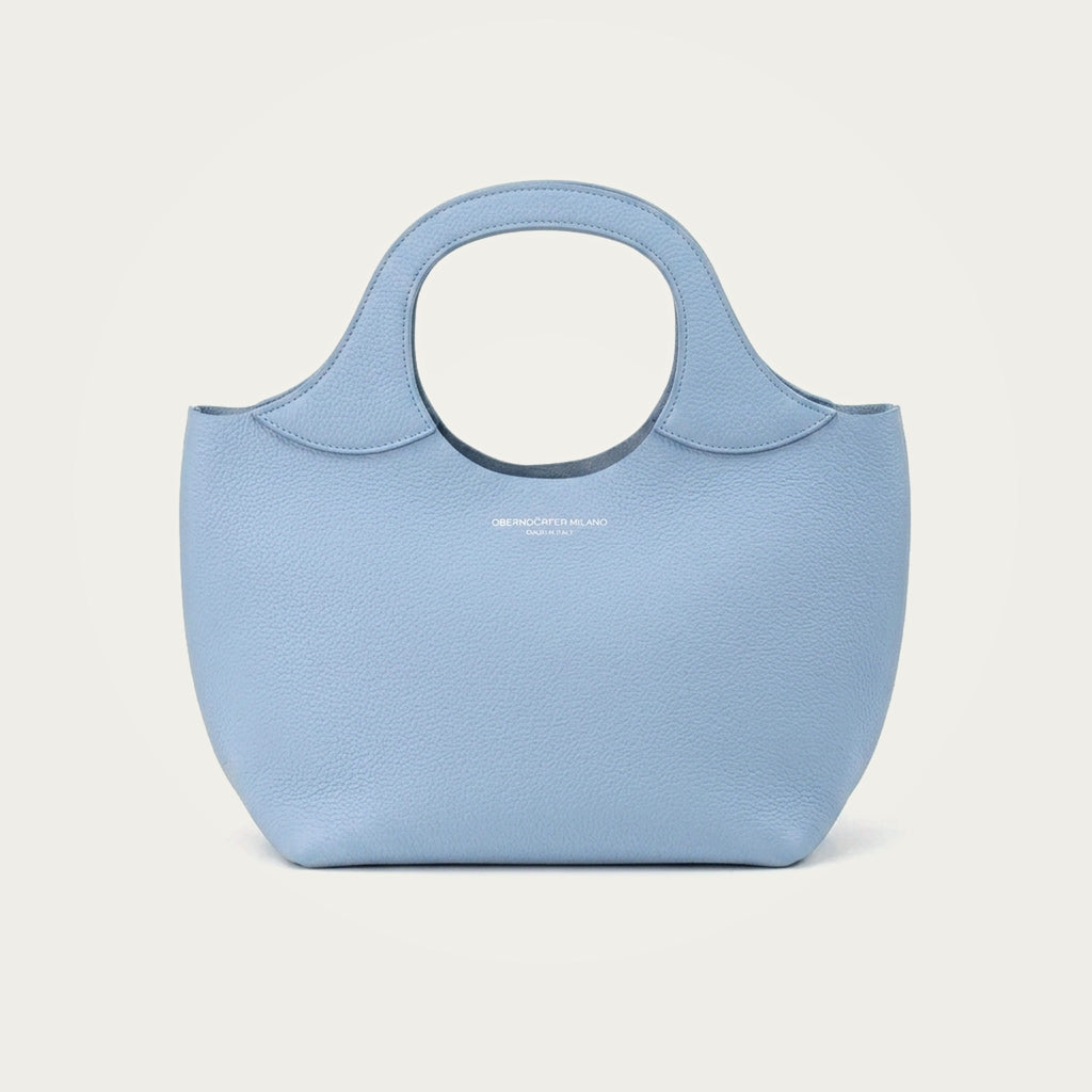 Bag Model 017 in light blue Togo leather on an ivory studio ground