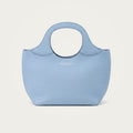Bag Model 017 in light blue Togo leather on an ivory studio ground