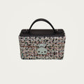 The Mirror Handbag in black tweed on an ivory studio ground