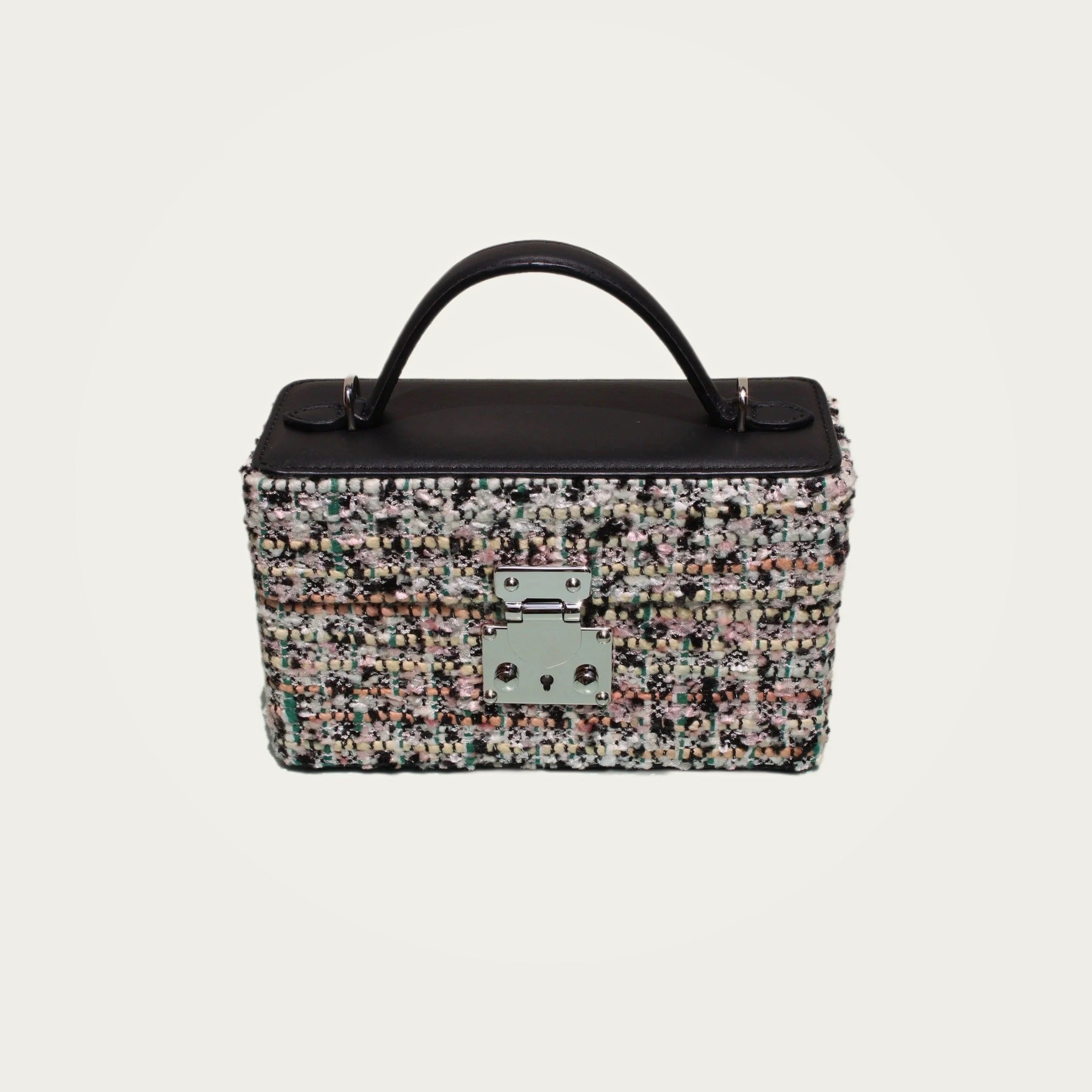 The Mirror Handbag in black tweed on an ivory studio ground