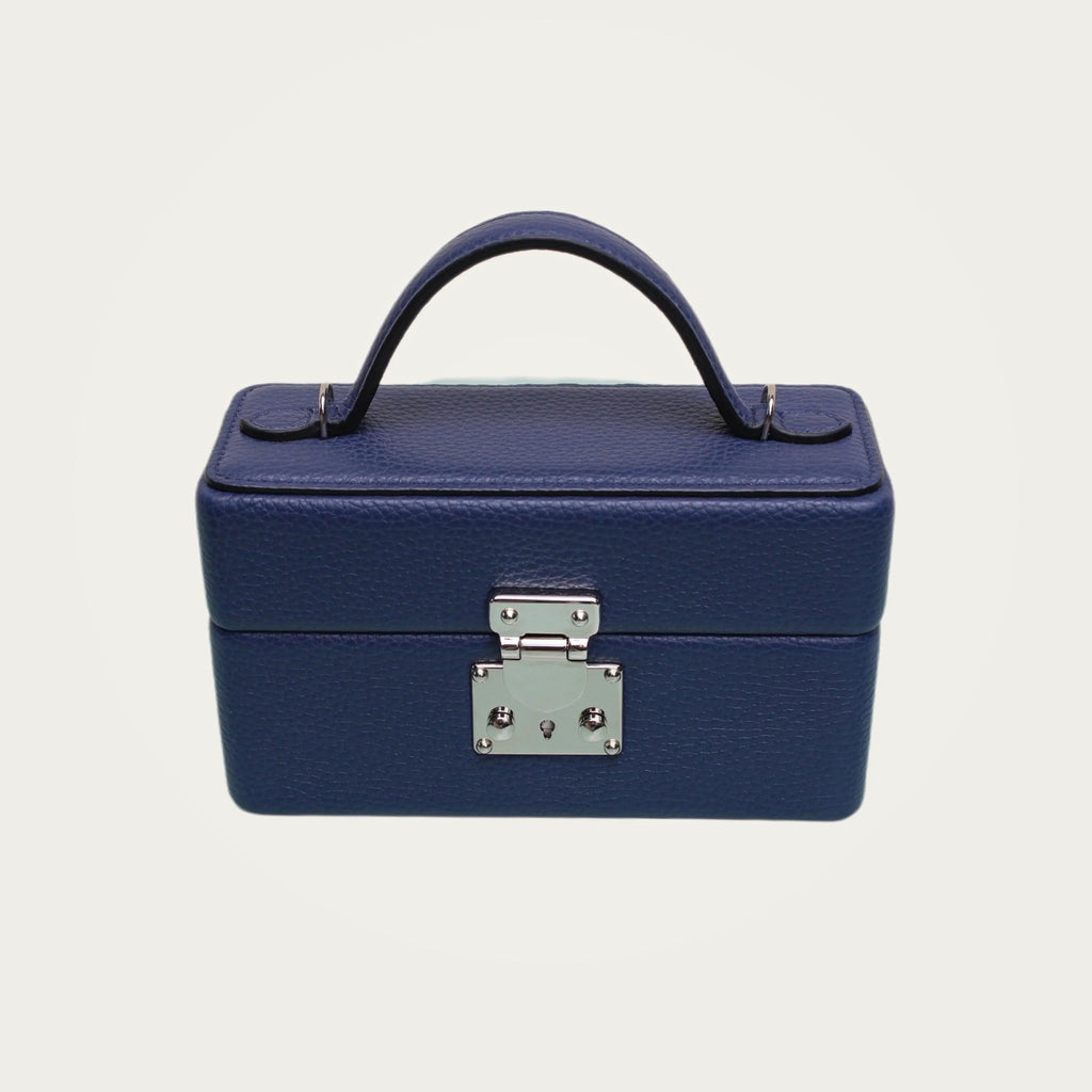 The Mirror Handbag in blue leather on an ivory studio ground