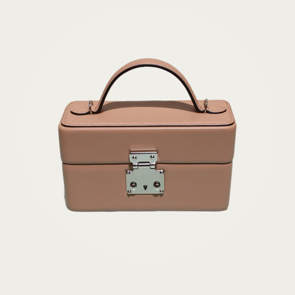 The Mirror Handbag in nude leather on an ivory studio ground