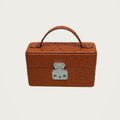 The Mirror Handbag in Ostrich on an ivory studio ground